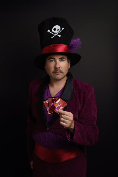 Self Portrait of Matt D wearing Dr. Facilier costume from The Princess and the Frog. Holding tarot cards.