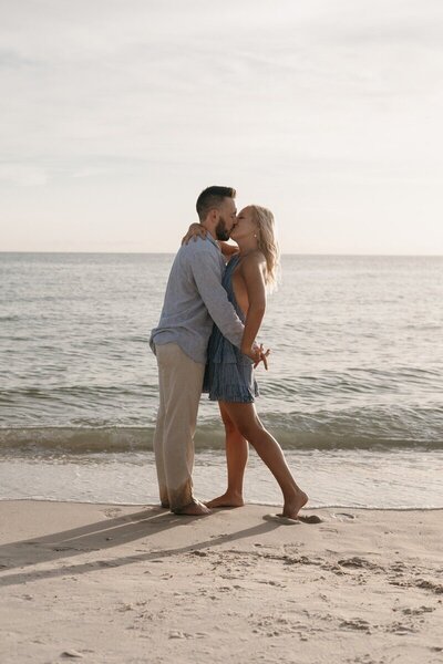 Groom-to-be proposing to his partner on the beach, photographed by Tampa wedding photographer, Priscila Del Cristo.