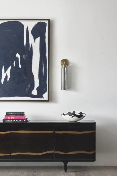 JSF Design entryway featuring a custom light, statement art, and a styled console