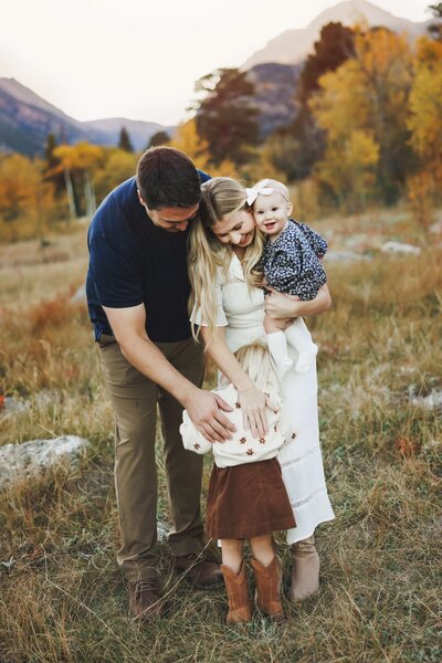 Children watching their parents kiss in a field in Fort Collins, Colorado