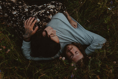 couple lying in wildflower field