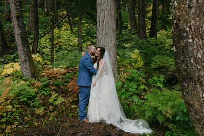 A couple standing in a forrest in Girdwood, Alaska. 