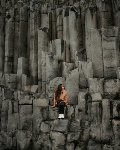 woman sitting in mountain side