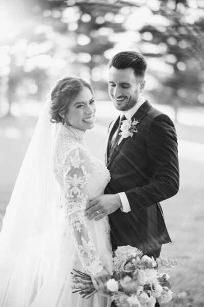 Newlyweds smile and have fun outdoors at their Legacy Club Cherry Hill wedding.