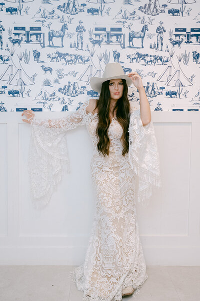 Editorial bridal portrait in ivory lace dress and white hat, captured by a luxury Austin wedding photographer for timeless wedding inspiration across Texas and beyond