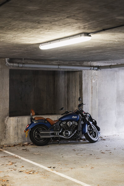 Motorcycle in a garage under a light bar