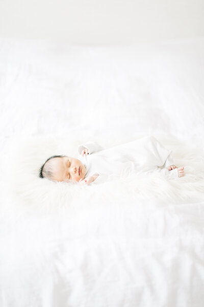 baby on bed during kent island newborn portraits
