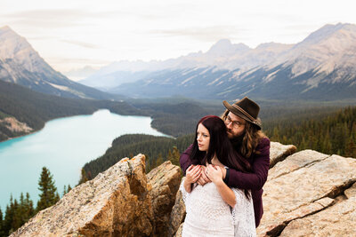 Elopement couple enjoying the view of a blue lake in Banff National park.  They are enjoying their Elopement day.