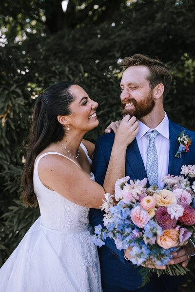Bride and groom laughing at Pittsburgh Botanical Gardens wedding. 