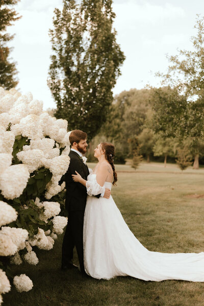 bride and groom embrace at wedding venue in peoria il