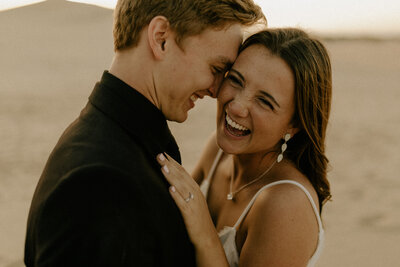 Close up photo of a couple hugging and laughing