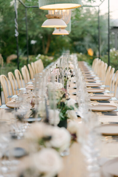 japandi formal wedding reception setting with light wood chairs and neutral tablescape