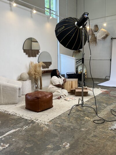 woman sitting on rug being photographed