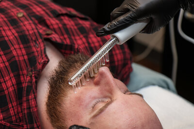 Esthetician giving a Men's skincare treatment in Albuquerque