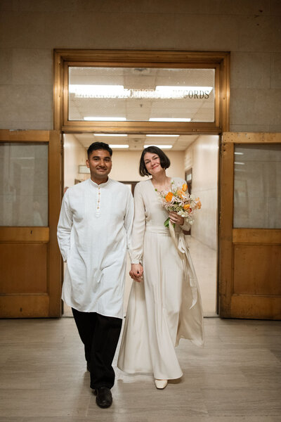 Brooklyn city hall couple with kamperett dress walking through marriage bureau