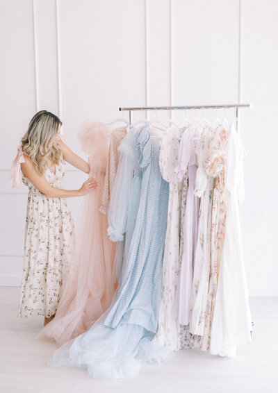 Nichole Pach wearing a floral dress looking at beautiful dresses