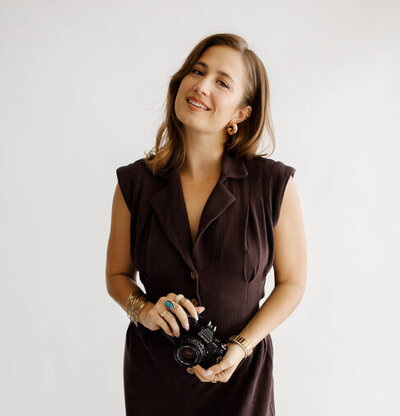 Girl with camera in her hands taking a picture