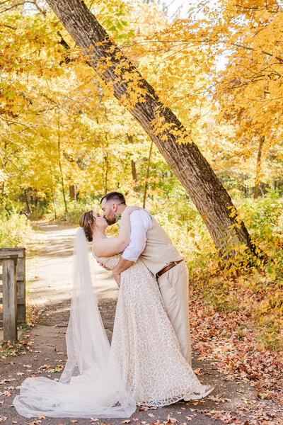Dip kiss fall  golden yellow leaves wedding bride and groom picture in the Milwaukee, Wisconsin area.