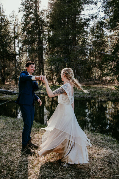 Groom feeding bride a bite of chocolate cake during an intimate elopement celebration at Sand Harbor in Lake Tahoe, surrounded by boulders and natural decor with joyful expressions.