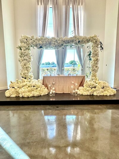 Large elegant white floral arch for wedding