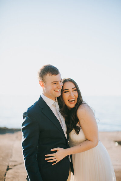 Bride and groom laugh together