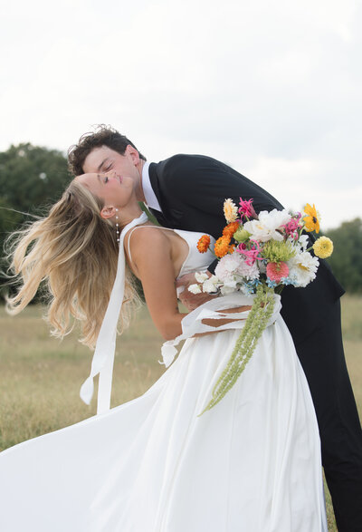 bride and groom laughing while holding each other