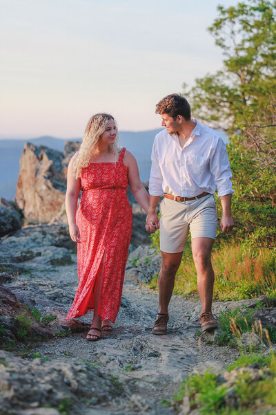 couple stands together on mountainside for engagement in virginia