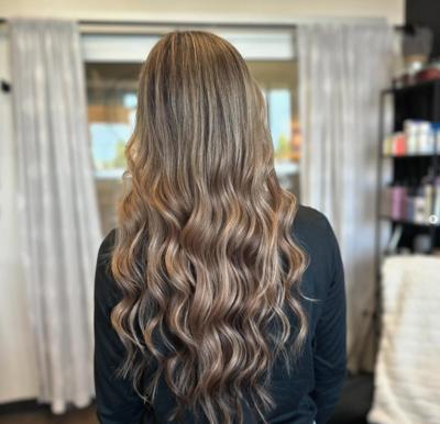 Dimensional brunette hair with soft waves after cut and color service at Lavender & Ink Studios