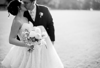Bride and groom sharing a kiss during their South Florida beach wedding coordinated by Ray of Sunshine Weddings.