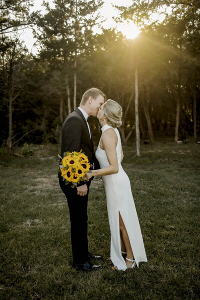 Just married couple kisses in the sunshine in north Texas