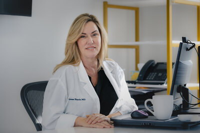 Dr. Terese Harris MD in White Doctors coat Headshot
