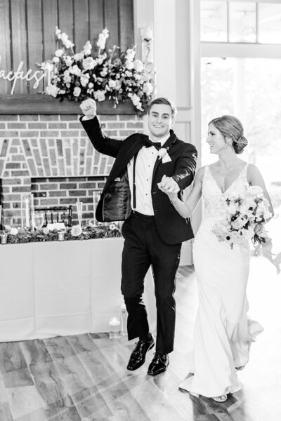 bride and groom excited as they enter reception