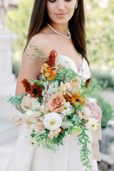 stunning bride holds lush floral bridal bouquet