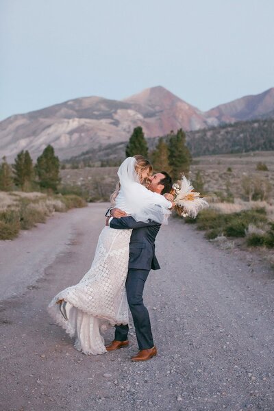 A bride and groom dance while in view of the mountains at Mammoth Lakes on their wedding day. 