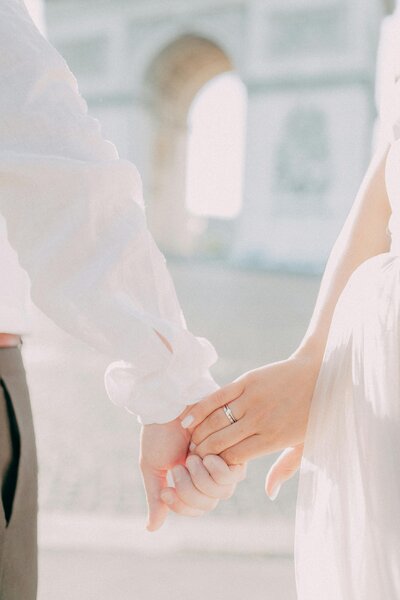 holding hands, wedding ring showing
