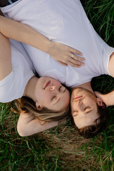 couple embracing on ground atlanta park