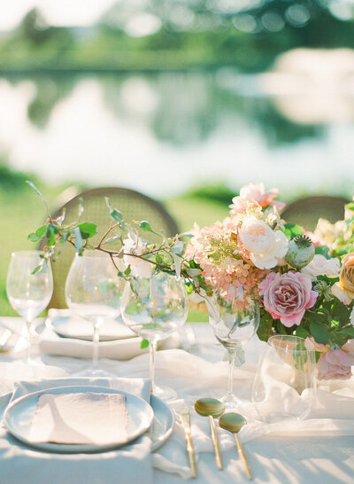 Wedding Reception Table Setting with Pink Flowers Cups Plates and Menus Photo