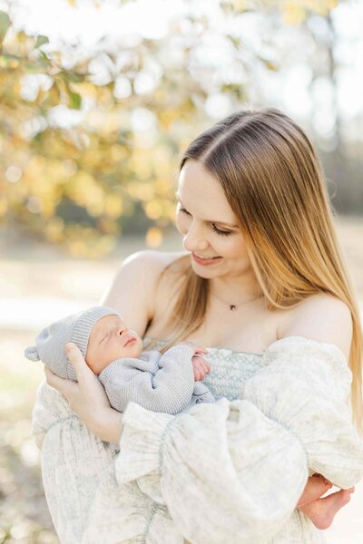 new mom holds her baby in houston nature