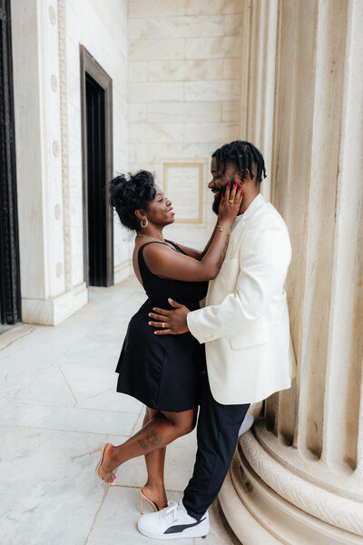 An engaged couple posing at Cleveland Museum of Art. 