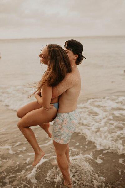 man embracing woman from behind