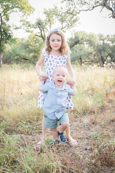 brither and sister together in a field
