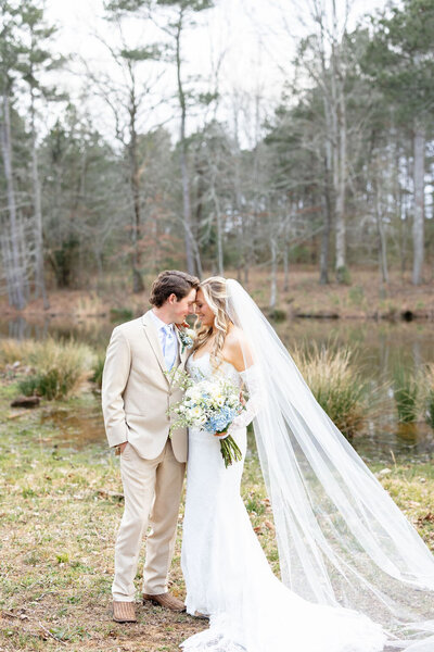 Bride and groom posing by a pond in Birmingham — Madison Abernathy Photo