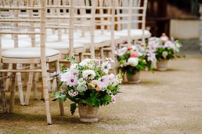 Aisle flowers for an outdoor ceremony at Clevedon Hall 