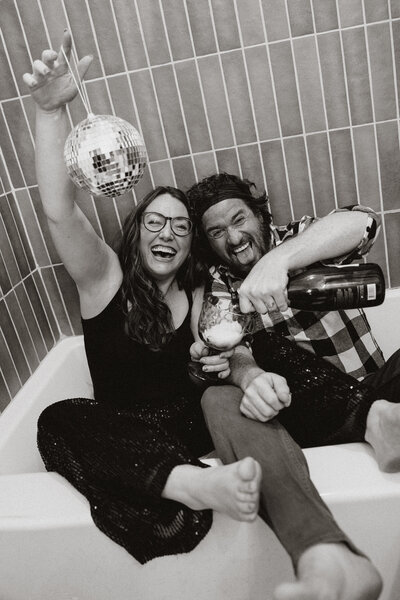 Couple partying in a bathtub with champagne and a disco ball in Breckenridge, Colorado.