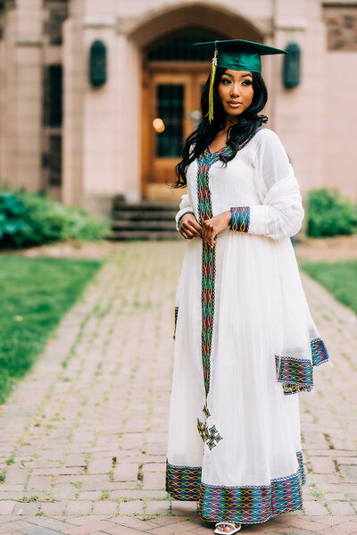 high school graduate posing in traditional Ethiopian clothing in university of Washington quad