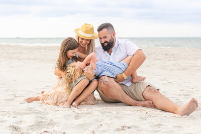 Family of four on the beach in Jacksonville, FL