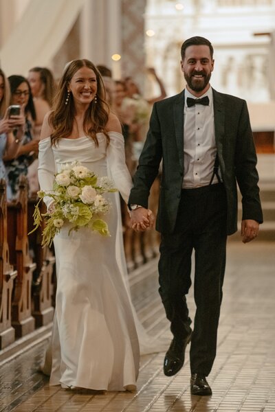 bride and groom walking back dow the aisle after getting married