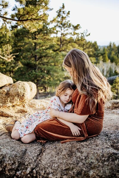 Mom kisses her daughter at an outdoor session