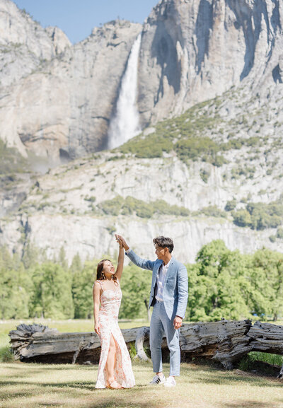 Couple looking at Lower Yosemite Falls at a stop during their Yosemite Elopement.