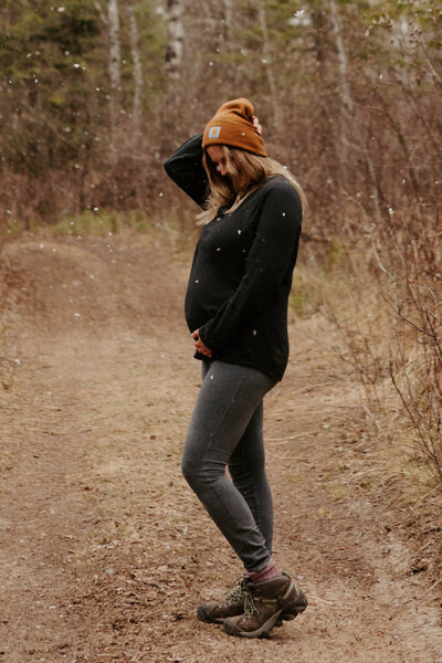 pregnant mother posing on trail